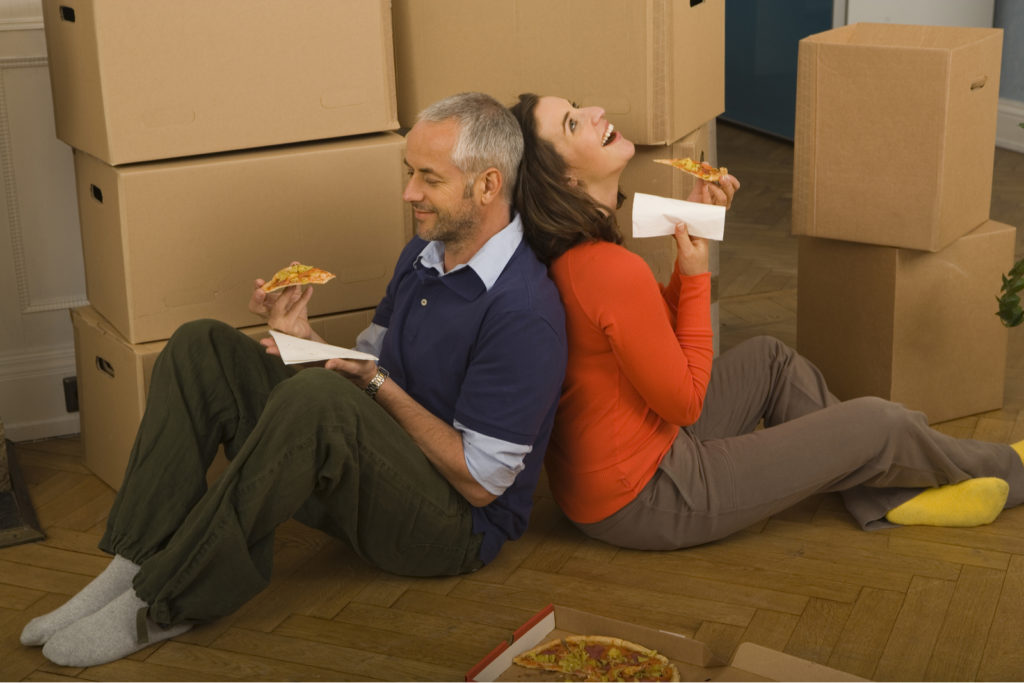 Couple Eating Food While Moving House