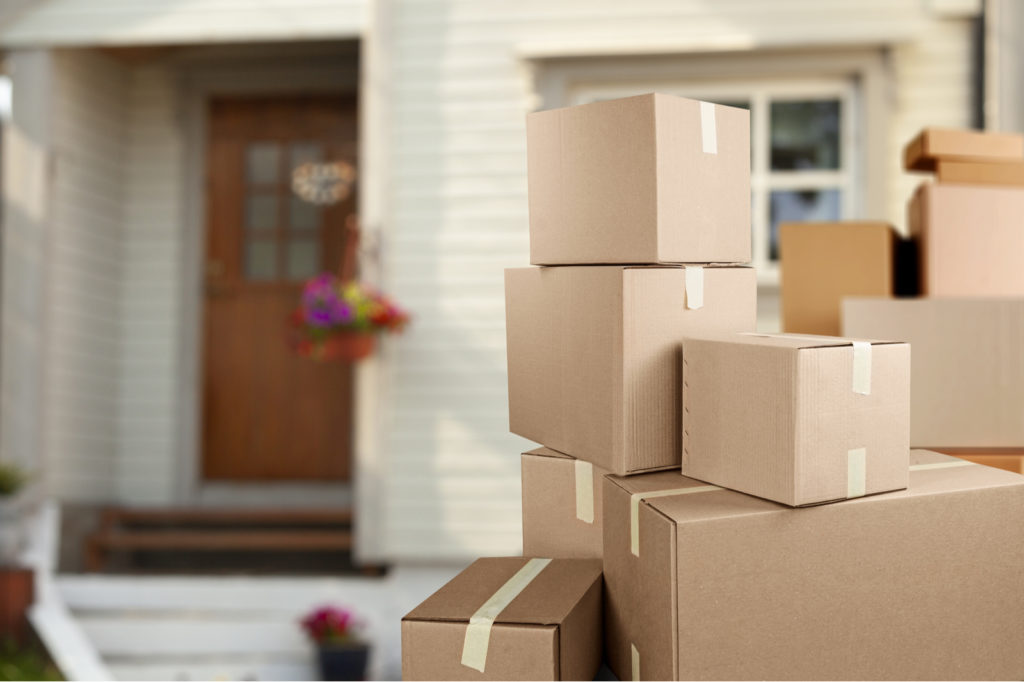 Stacked Moving Boxes Outside Home